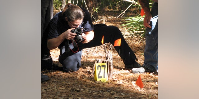 Nov. 11: Diane Robinson of the American Humane Association marks and photographs details of a staged crime scene during a veterinary forensics seminar at the University of Florida in Gainesville, Fla.