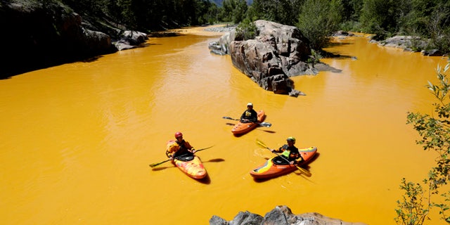FILE: Aug. 6, 2015: Kayaker in the Animas River near Durango, Colo., in water colored yellow from a mine waste spill.