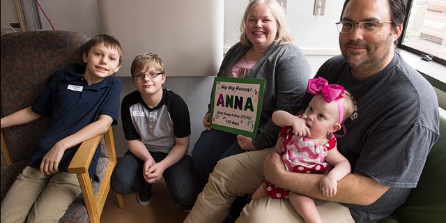 Collin, Seth, Jill and Michael Richards smile with Anna before she is discharged.