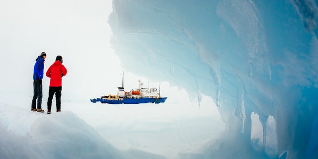 Passengers from the trapped Russian ship MV Akademik Shokalskiy walk around the ice, Dec. 31, 2013.