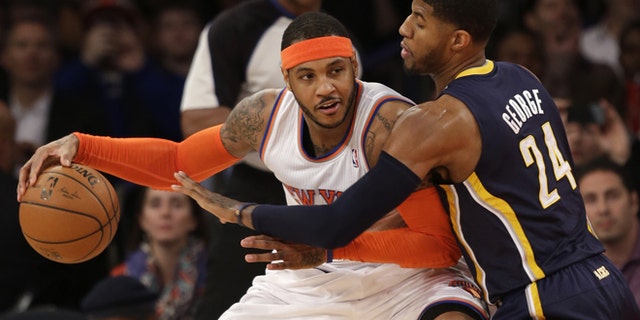 Anthony tries to move around Indiana Pacers' Paul George in this March 19, 2014, file photo.