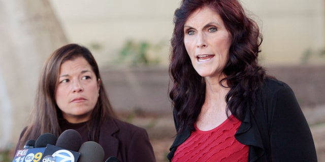 FILE - In this Thursday, Sept. 20, 2012, file photo, Cindy Lee Garcia, one of the actresses in "Innocence of Muslims," right, and attorney M. Cris Armenta hold a news conference in Los Angeles asking a judge to issue an injunction demanding a 14-minute trailer for the film be pulled from YouTube. A federal appeals court on Monday, May 18, 2015 overturned an order for YouTube to take down the anti-Muslim film that sparked violence in the Middle East and death threats to actors. (AP Photo/Jason Redmond, File)