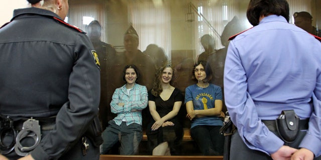Aug. 17, 2012: Feminist punk group Pussy Riot members, from left, Yekaterina Samutsevich, Maria Alekhina and Nadezhda Tolokonnikova sit in a glass cage at a court room in Moscow, Russia .