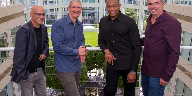 In this image provided by Apple, from left to right, music entrepreneur and Beats co-founder Jimmy Iovine, Apple CEO Tim Cook, Beats co-founder Dr. Dre, and Apple senior vice president Eddy Cue pose together at Apple headquarters in Cupertino, Calif., Wednesday, May 28, 2014. Apple is striking a new chord with a $3 billion acquisition of Beats Electronics, a headphone and music streaming specialist that also brings the swagger of rapper Dr. Dre and recording impresario Jimmy Iovine.