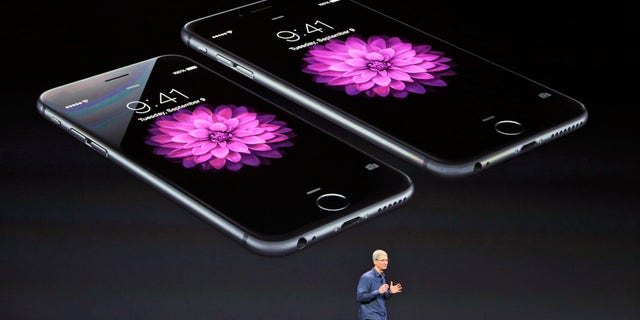 Apple CEO Tim Cook discusses the new iPhone 6 and iPhone 6 plus on Tuesday, Sept. 9, 2014, in Cupertino, Calif. The iPhone 6 will have a screen measuring 4.7 inches, while the iPhone 6 Plus will be 5.5 inches. (AP Photo/Marcio Jose Sanchez)