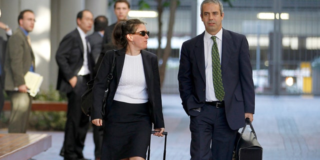 Aug 24, 2012: Kevin Johnson, right, and Victoria Maroulis, left, attorneys for Samsung, leave the US Courthouse and Federal building after a jury reached a decision in the Apple Samsung trial in San Jose, Calif. The jury ordered Samsung to pay Apple $1.05 billion. An appeal is expected.