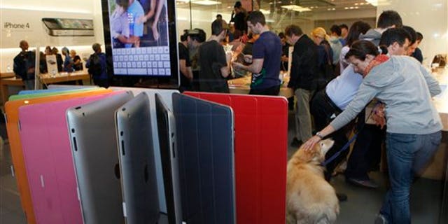 March 11: Shoppers buy the new iPad 2 at The Grove Apple store in Los Angeles. (AP)
