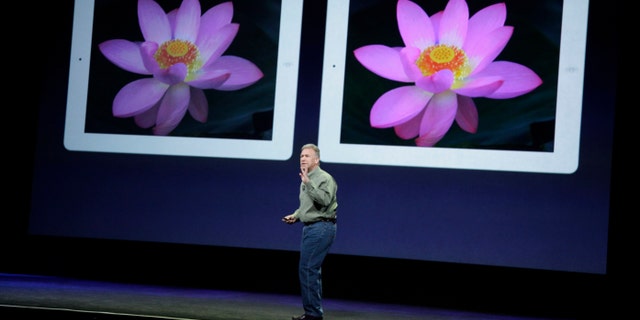 March 7, 2012: Apple's senior vice president of Worldwide Marketing Phil Schiller stands in front of an old iPad, left, and new iPad, right, during an Apple event in San Francisco.