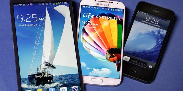 Aug. 28, 2013: The 6.3-inch Samsung Galaxy Mega, left, the 5.0-inch Samsung Galaxy S4, center, and 4.0-inch Apple iPhone 5. Reports suggest Apple is investigating larger screen sizes for its flagship phone, up to 6 inches.