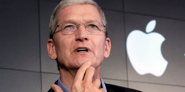 Apple CEO Tim Cook responds to a question during a news conference at IBM Watson headquarters, in New York, Thursday, April 30, 2015.
