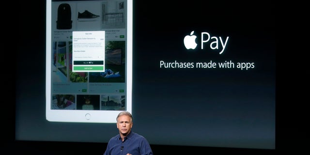 Phil Schiller, Apple's senior vice president of worldwide product marketing, discuss the features of the new Apple iPad Air 2 and Apple Pay during an event at Apple headquarters on Oct. 16, 2014.