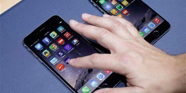 The iPhone 6 Plus, at left, and iPhone 6 are displayed on Sept. 9, 2014, in Cupertino, Calif.