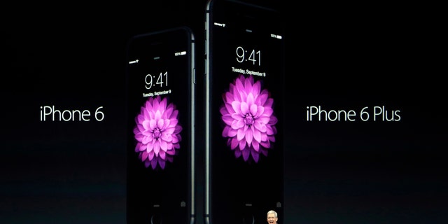 Apple CEO Tim Cook introduces the new iPhone 6 and iPhone 6 Plus on Tuesday, Sept. 9, 2014, in Cupertino, Calif. (AP Photo/Marcio Jose Sanchez)
