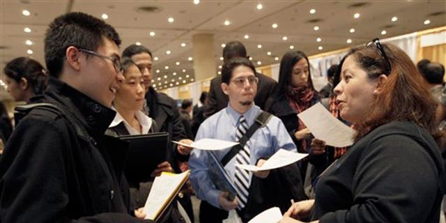 April 8: A recruiter speaks to job applicants during the 23rd annual CUNY Big Apple Job Fair, at the Jacob K. Javits convention center in New York.