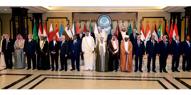 March 25, 2014: Arab leaders pose for a group photograph during the opening session of the Arab League Summit in Bayan Palace, Kuwait City.