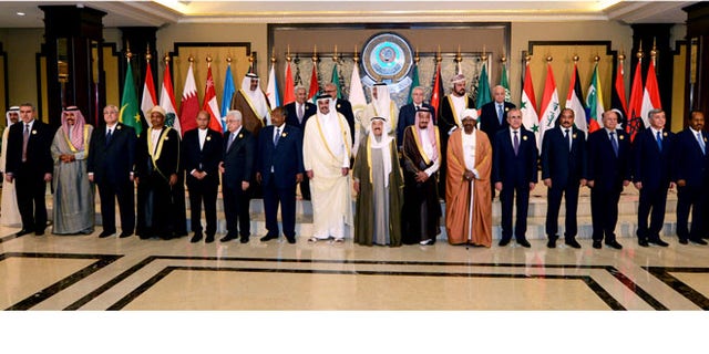 March 25, 2014: Arab leaders pose for a group photograph during the opening session of the Arab League Summit in Bayan Palace, Kuwait City.