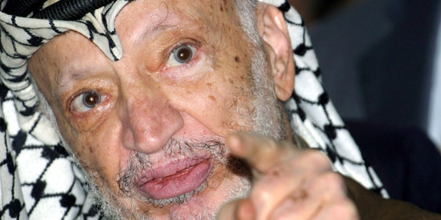 Sept. 4, 2004: Palestinian President Yasser Arafat talks to the media after opening a voter registration drive at a polling station at his headquarters in the West Bank city of Ramallah.