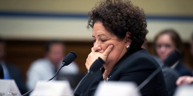 FILE - In this June 16, 2015 file photo, Office of Personnel Management (OPM) Director Katherine Archuleta pauses while testifying on Capitol Hill in Washington. The White House waited roughly four weeks before telling the public that hackers had stolen the personal information of millions of people associated with the federal government, two people directly involved with the investigation tell The Associated Press. In providing a more detailed chronology of the break-in at the U.S. Office of Personnel Management, the two people say the White House decided June 2 to disclose it that week. OPM and the Homeland Security Department publicly confirmed the data thefts on June 4, shortly after the AP broke the story. They spoke on condition of anonymity because parts of the case and techniques being used are classified. (AP Photo/Cliff Owen)