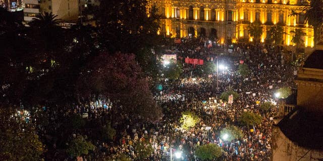 FILE - In this Aug. 25, 2015 file photo, demonstrators gather outside the government house claiming fraud in Sunday's election for governor in Tucuman, Argentina. A court in Tucuman province ruled Wednesday, Sept. 16, 2015 that irregularities were so widespread in the Aug. 23 vote that new elections are necessary. Dozens of ballot boxes were burned and errors were found in the vote count that showed a pro-government candidate winning by 52 percent to 40 percent. (Sol Almidez/Infoto via AP, File)