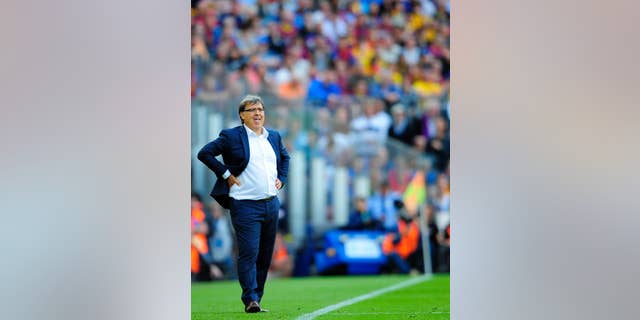 FILE - In this May 17, 2014, file photo, FC Barcelona's coach Gerardo Martino, from Argentina, looks on during a Spanish La Liga soccer match between FC Barcelona and Atletico Madrid at the Camp Nou stadium in Barcelona, Spain. The Argentine Football Association announced Tuesday August 12, 2014, that is has named Martino as the Argentina National Soccer Team head coach. (AP Photo/Manu Fernandez, File)