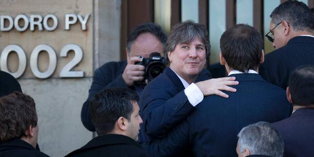 FILE - In this June 9, 2014 file photo, Argentina's Vice President Amado Boudou looks back as he enters a federal court in Buenos Aires, Argentina. The Vice President is back in court, this time over false data in the papers of an old car that he bought about 20 years ago. Boudou appeared before a federal judge Wednesday, July 23, 2014, and presented a written statement instead of speaking on his defense. Boudou is accused of transferring a Honda CRX automobile to his name irregularly in 2003. (AP Photo/Natacha Pisarenko, File)
