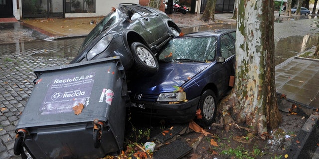April 2, 2013: Cars and garbage containers lay piled up after flash flooding caused damage overnight in Buenos Aires, Argentina. According to city officials, at least five people were killed during the heavy rains.