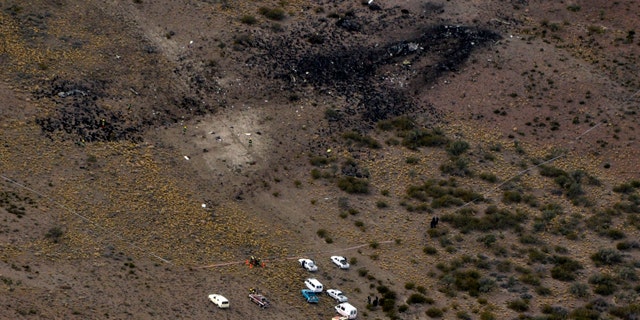 May 19: Firefighters inspect the debris of a plane that crashed and exploded in Argentina's southern Patagonia region killing all 22 on board and disintegrating in the air.