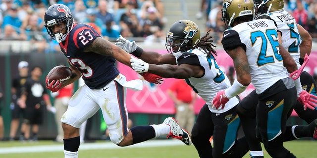 Arian Foster of the Houston Texans rushes against Davon House of the Jacksonville Jaguars on Oct. 18, 2015.
