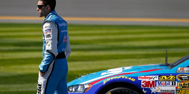 DAYTONA BEACH, FL - FEBRUARY 16: Aric Almirola, driver of the #43 Smithfield Ford, stands on the grid during qualifying for the NASCAR Sprint Cup Series Daytona 500 at Daytona International Speedway on February 16, 2014 in Daytona Beach, Florida. (Photo by Jonathan Ferrey/Getty Images)