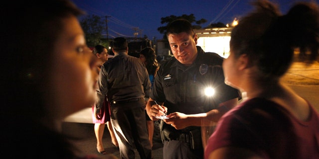 TUCSON, AZ - MAY 30: Tucson Police Officer Angel Ramirez interviews teenage girls about their involvement in a fight May 30, 2010 in Tucson, Arizona. Ramirez works in the city's predominately Hispanic south side. The Tucson Police Department is currently gearing up to begin training its officers on the implementation of the state?s controversial new immigration law SB 1070. Although a Tucson police officer was one of the first to file suit in federal court challenging the new law, many rank and file officers support the legislation while the Arizona Chiefs of Police have criticized it. (Photo by Scott Olson/Getty Images)