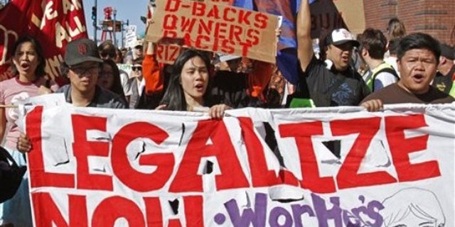 Protestors outside AT&T Park join in the "National Day of Action Against SB1070" by picketing the Arizona Diamondbacks vs. San Francisco Giants baseball game Saturday, May 29, 2010, in San Francisco. The protest was held in support of the Boycott Arizona campaign.(AP)