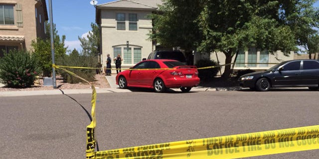 Aug. 30, 2015: Police stand outside a house where twin 2-year-old boys drowned in Avondale, Ariz. (KSAZ)