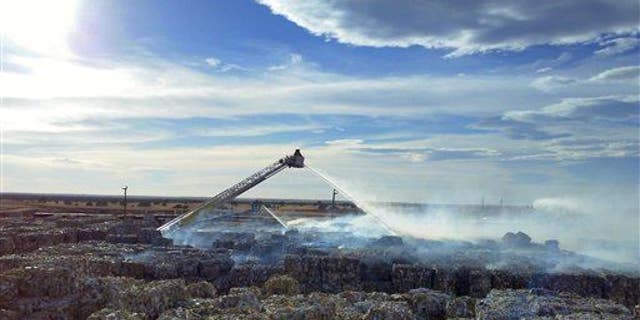 Firefighters in Snowflake, Arizona, douse a recycling fire in this file photo.