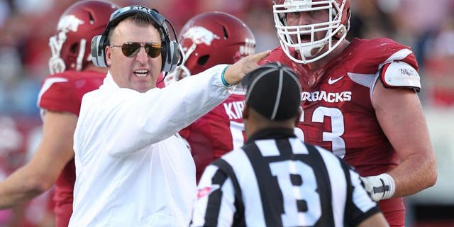 Oct 18, 2014; Little Rock, AR, USA; Arkansas Razorbacks head coach Bret Bielema and offensive tackle Dan Skipper (63) argue a call with an official during the game against the Georgia Bulldogs at War Memorial Stadium. Georgia defeated Arkansas 45-32. Mandatory Credit: Nelson Chenault-USA TODAY Sports