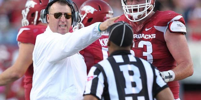 Oct 18, 2014; Little Rock, AR, USA; Arkansas Razorbacks head coach Bret Bielema and offensive tackle Dan Skipper (63) argue a call with an official during the game against the Georgia Bulldogs at War Memorial Stadium. Georgia defeated Arkansas 45-32. Mandatory Credit: Nelson Chenault-USA TODAY Sports