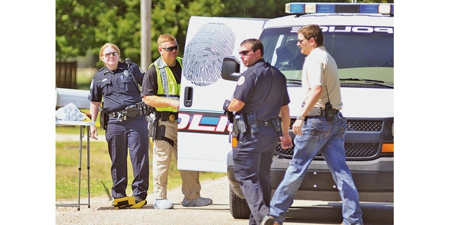 May 3, 2014: Jonesboro, Ark. police officers and crime scene analysts investigate a crime scene.  Jonesboro Sgt. Doug Formon said a man and a 13-year-old girl were killed Saturday afternoon inside a residence in east Jonesboro, Arkansas. Four other people, including two boys, were injured and were taken to hospitals in Memphis, Tennessee. He said the children, ages 8 and 10, were transported in critical condition. (AP Photo/The Jonesboro Sun, Rob Holt)