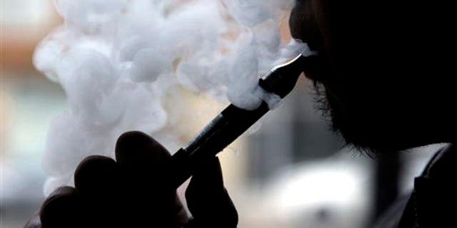 In this April 23, 2014 file photo, an e-cigarette is demonstrated in Chicago.
