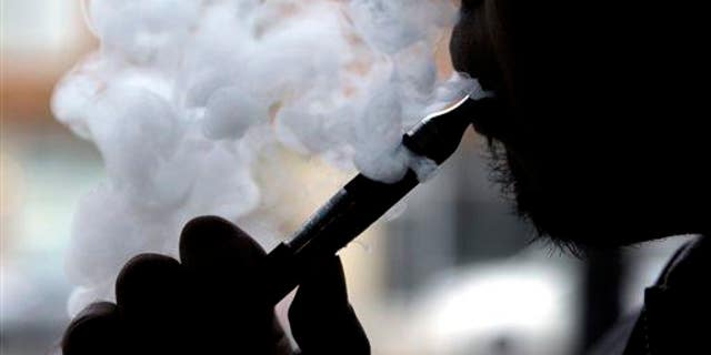 In this April 23, 2014 file photo, an e-cigarette is demonstrated in Chicago.