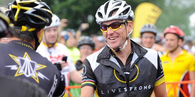 Aug. 22, 2010: This file photo shows Lance Armstrong, center, greeting fellow riders prior to the start of his Livestrong Challenge 10K ride for cancer in Blue Bell, Pa.
