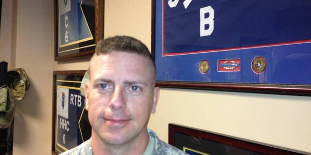 Retired Col. Bob Harkins poses for a photo on May 19, 2014, at Fort Campbell, Ky. Harkins has seen his son follow in his footsteps. Harkins led the "Rakkasans," the 187th Infantry Division, 3rd Brigade Combat Team of the 101st Airborne Division at Fort Campbell into combat at the Battle of Hamburger Hill in May 1969 in Vietnam. Four decades later, his son, Lt. Col. Patrick Harkins led the unit into combat in Afghanistan. (AP Photo/Brett Barrouquere)