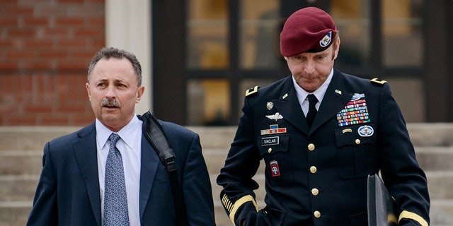 FILE - In this March 4, 2014, file photo, Brig. Gen. Jeffrey Sinclair, right, leaves the courthouse with his lawyers Richard Scheff, left, and Ellen C. Brotman, not pictured, following a day of motions at Fort Bragg, N.C. A military judge declined Monday, March 10, 2014, to dismiss sexual assault charges against Sinclair after reviewing what he said was evidence that political considerations influenced the military's handling of the case. (AP Photo/The Fayetteville Observer, James Robinson, File)