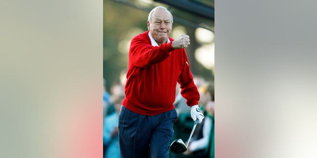 Arnold Palmer celebrates after his ceremonial tee shot before the first round of the Masters golf tournament in Augusta, Ga.