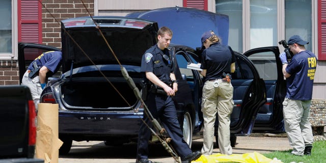 Law enforcement agents search a car at the home of reputed Connecticut mobster Robert Gentile in Manchester, Conn., Thursday, May 10, 2012. Gentile's lawyer A. Ryan McGuigan said at the time that the FBI warrant allowed the use of ground-penetrating radar and believes they were looking for paintings stolen from Boston's Isabella Stewart Gardner Museum.
