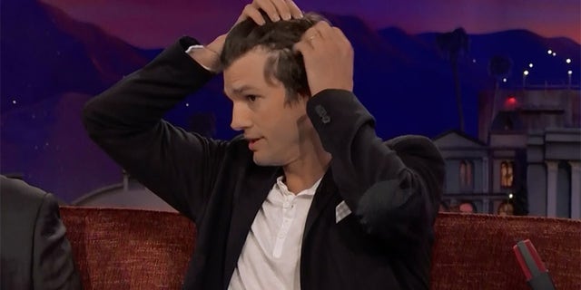 Ashton Kutcher revealed his receding hairline to TV host Conan O'Brien Monday night.