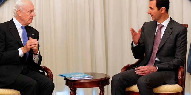 Nov. 10, 2014: In this photo released by the Syrian official news agency SANA, Syrian President Bashar Assad, right, speaks with United Nations special envoy to Syria Staffan de Mistura in Damascus, Syria. (AP/SANA)
