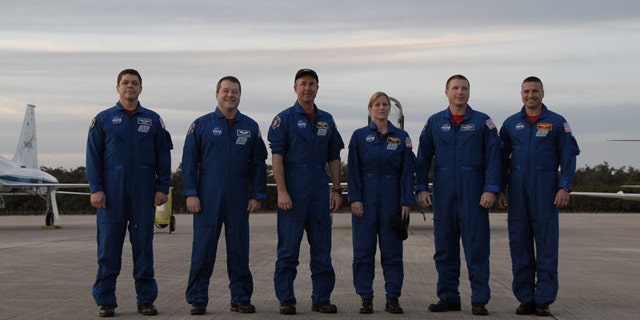 The six-astronaut crew of shuttle Endeavour's STS-130 mission pose for a photo at NASA's Shuttle Landing Facility after arriving Jan. 18, 2010 for prelaunch training. Liftoff is set for Feb. 7.