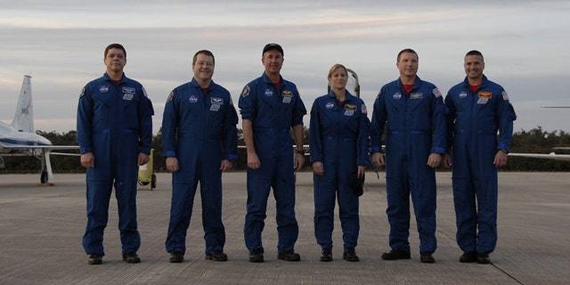 The six-astronaut crew of shuttle Endeavour's STS-130 mission pose for a photo at NASA's Shuttle Landing Facility after arriving Jan. 18, 2010 for prelaunch training. Liftoff is set for Feb. 7.