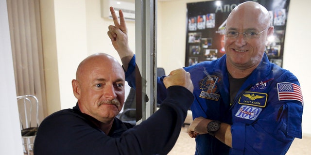 NASA astronaut Scott Kelly (R), member of the 43 International Space Station crew, and his twin brother Mark pose after a news conference at Baikonur cosmodrome March 26, 2015.