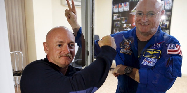 NASA astronaut Scott Kelly (R), member of the 43 International Space Station crew, and his twin brother Mark pose after a news conference at Baikonur cosmodrome March 26, 2015.