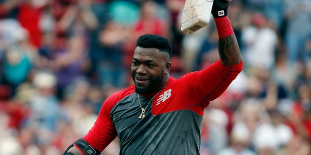 Boston Red Sox's David Ortiz holds up second base after hitting the game-winning RBI double during the 11th inning of a baseball game against the Houston Astros in Boston, Saturday, May 14, 2016. The Red Sox won 6-5. (AP Photo/Michael Dwyer)